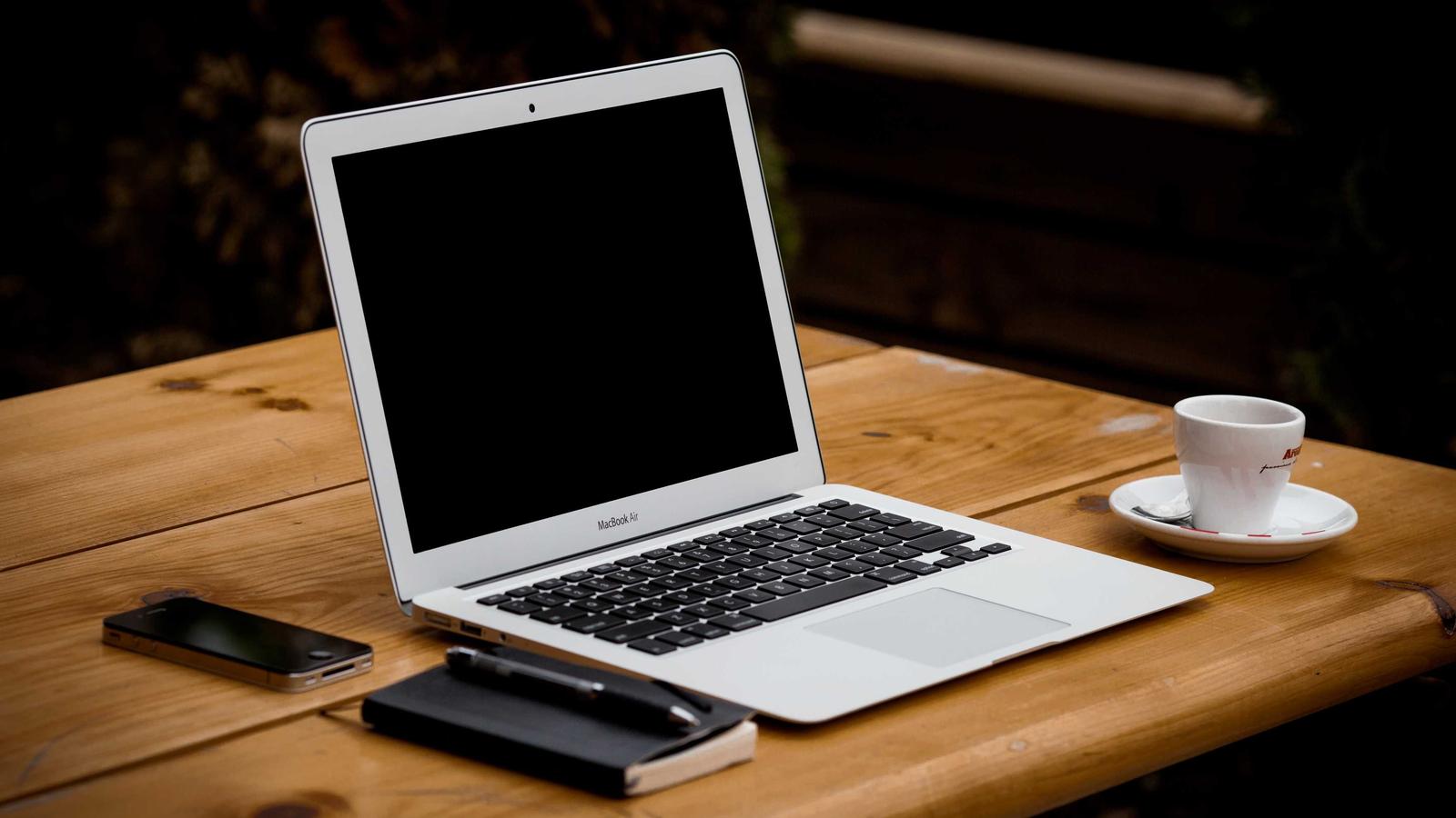 Developer workspace with laptop and notes